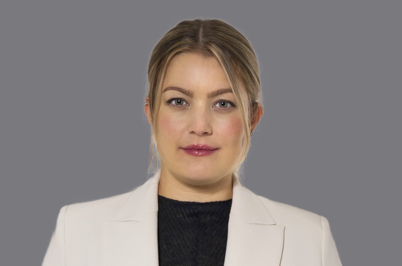 Lächelnde blonde Fau in weißem Blazer